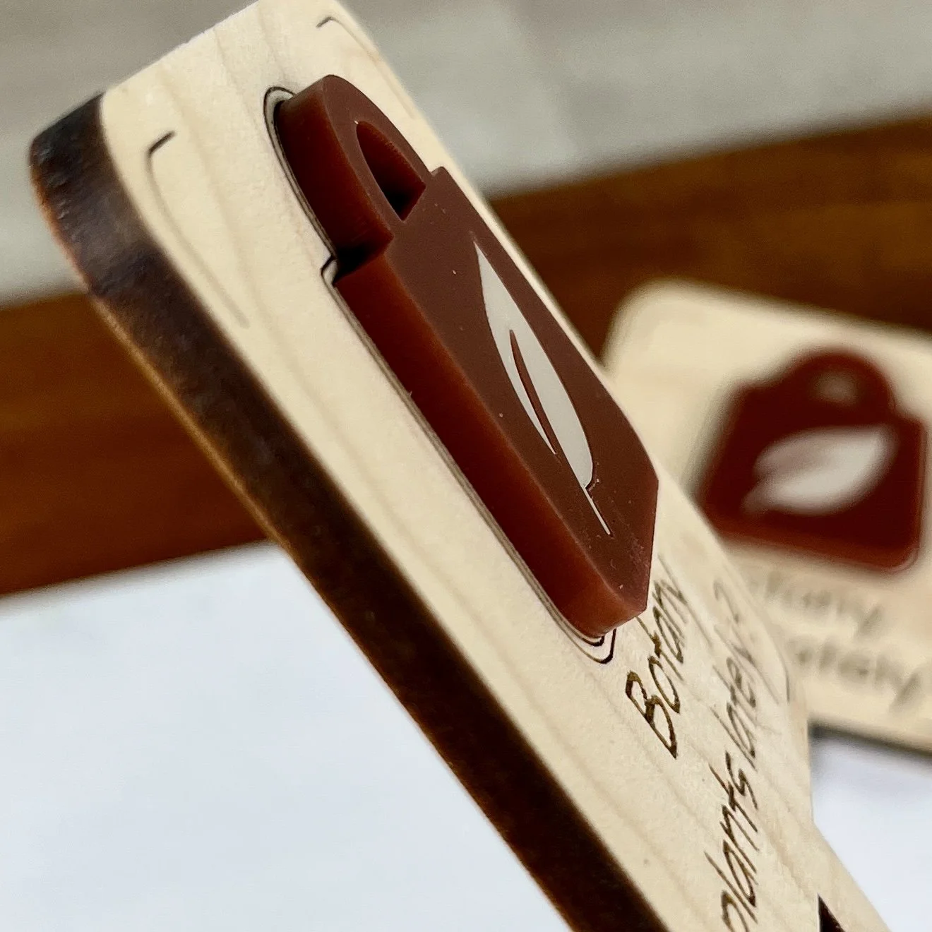 angled view maple bookmark featuring an acrylic garden centre shopping bag embellishment engraved with the phrase "All my friends are dead".