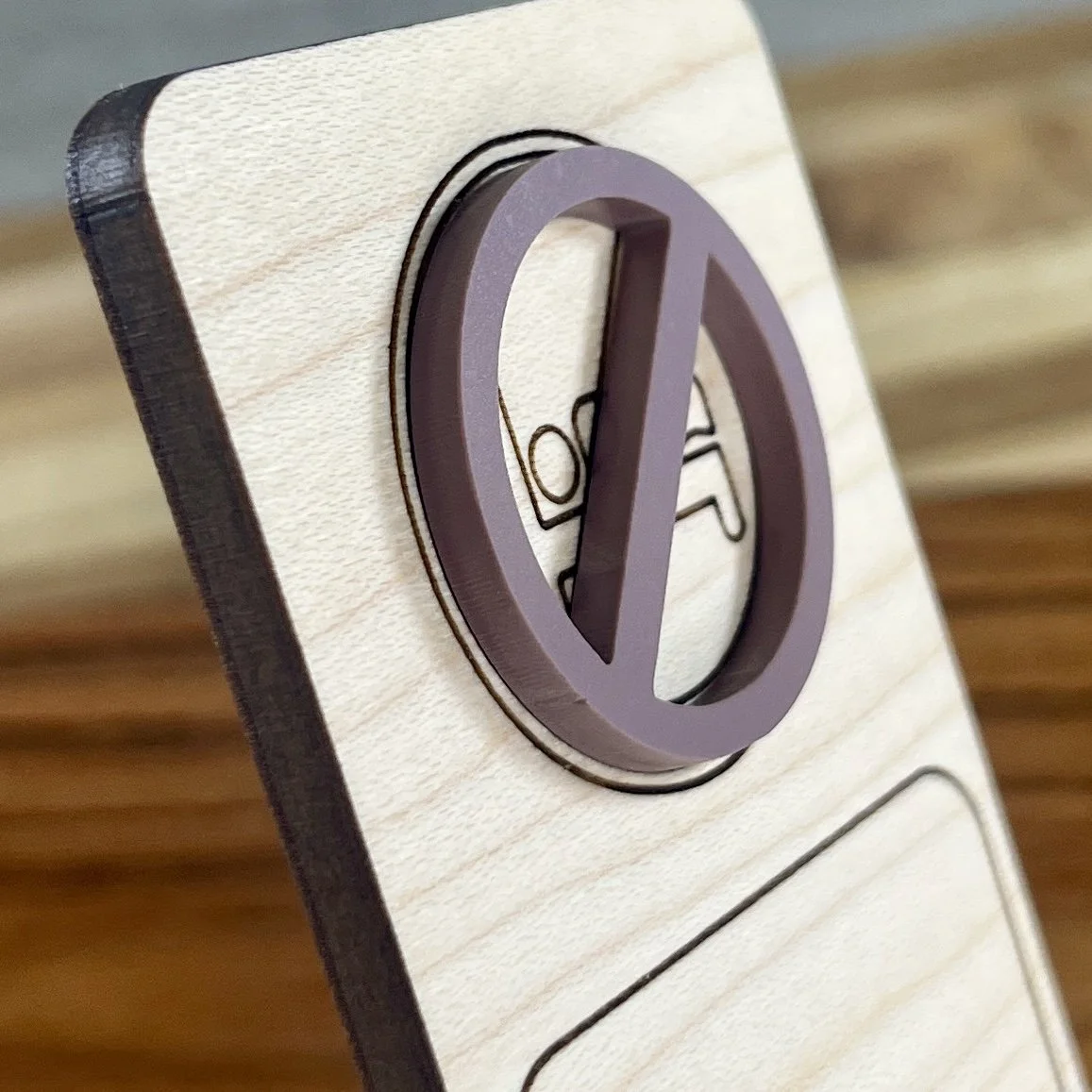 angled view maple bookmark featuring a mauve no bedtime symbol embellishment engraved with the phrase "I read past my bedtime".