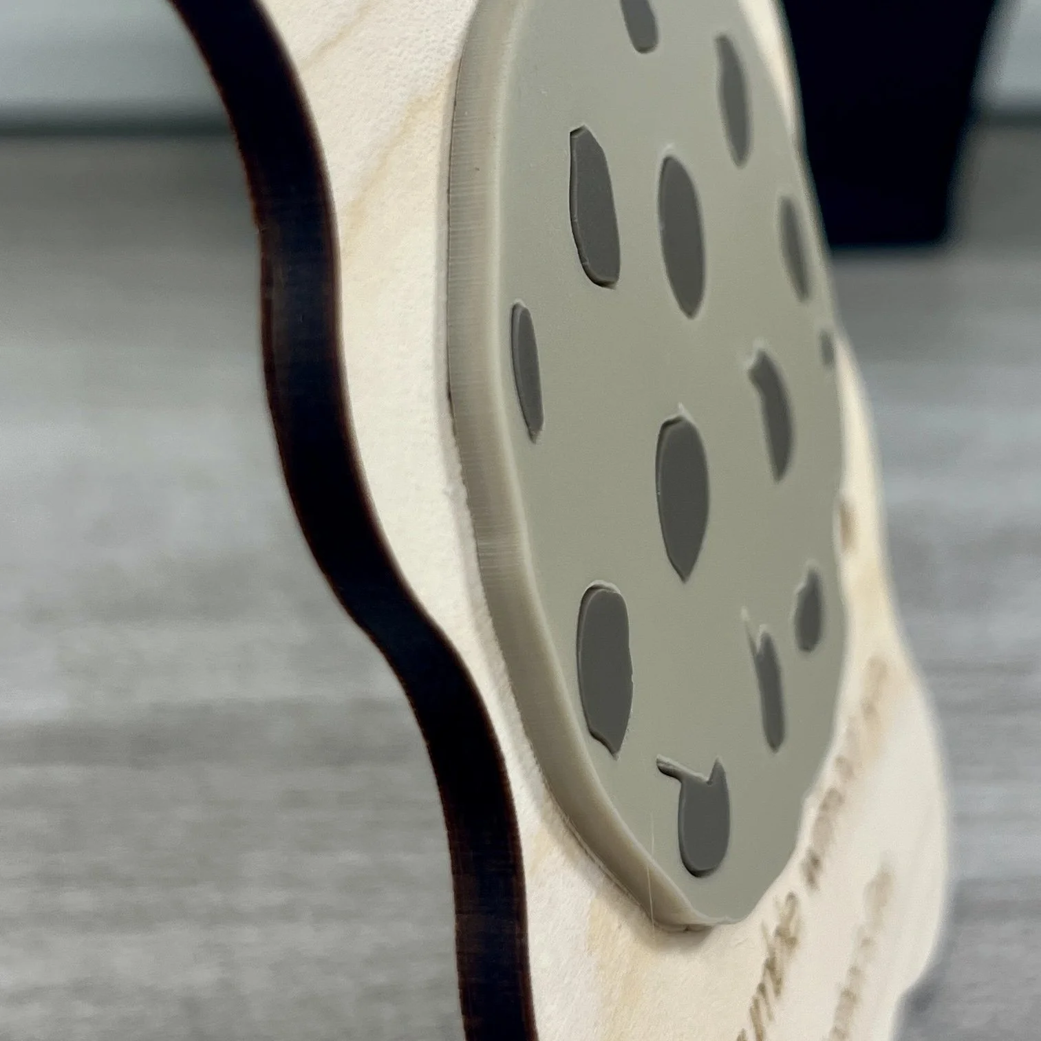 side view of laser cut wavy-edged maple magnet featuring raised acrylic chocolate chip cookie highlighting the depth and texture of the product.