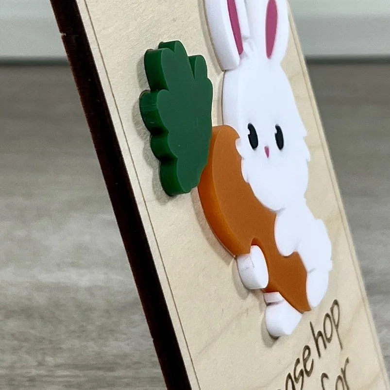 Side view of laser cut maple wood Easter bunny door hanger with raised Easter bunny graphics highlighting depth and texture of product.
