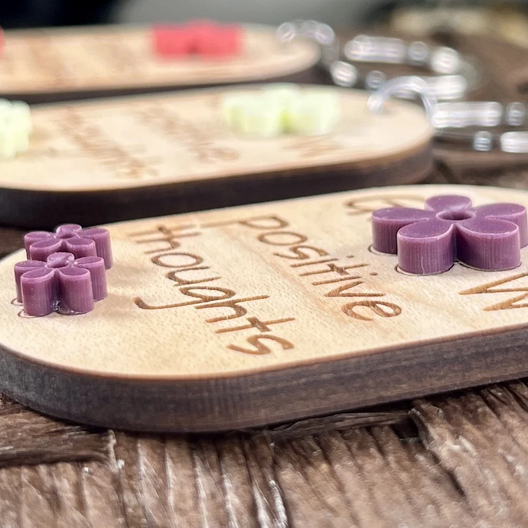 side view of laser cut maple wood keychain showing 3D application of 3 matte acrylic sugar plum coloured flowers grow positive thoughts gift Canada.