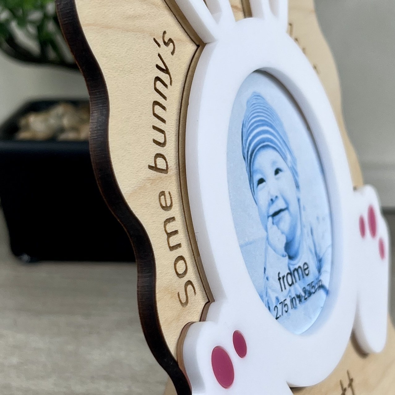Side view of laser-cut maple wood Baby's First Easter photo frame with bunny ears highlighting the depth and texture of the product.