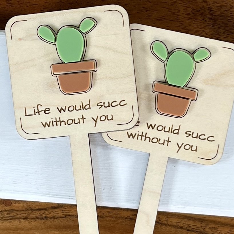 flat lay maple plant stake featuring a potted succulent embellishment engraved with the phrase "Life would succ without you".