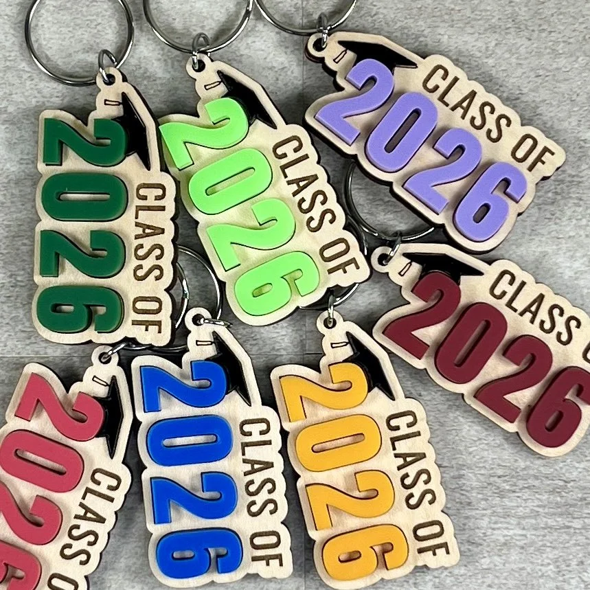 Group of Class Of graduation keychains in multiple acrylic colours and years, arranged together to show available colour options.