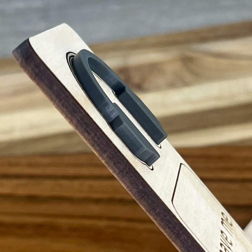 angled view maple bookmark featuring a charcoal grey acrylic headphones embellishment engraved with the phrase "Leave Me Alone I’m Reading".