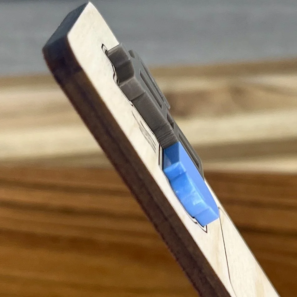 angled view maple bookmark featuring blue acrylic coffee cup and stovetop coffee pot embellishment engraved with the phrase "Books and Coffee".