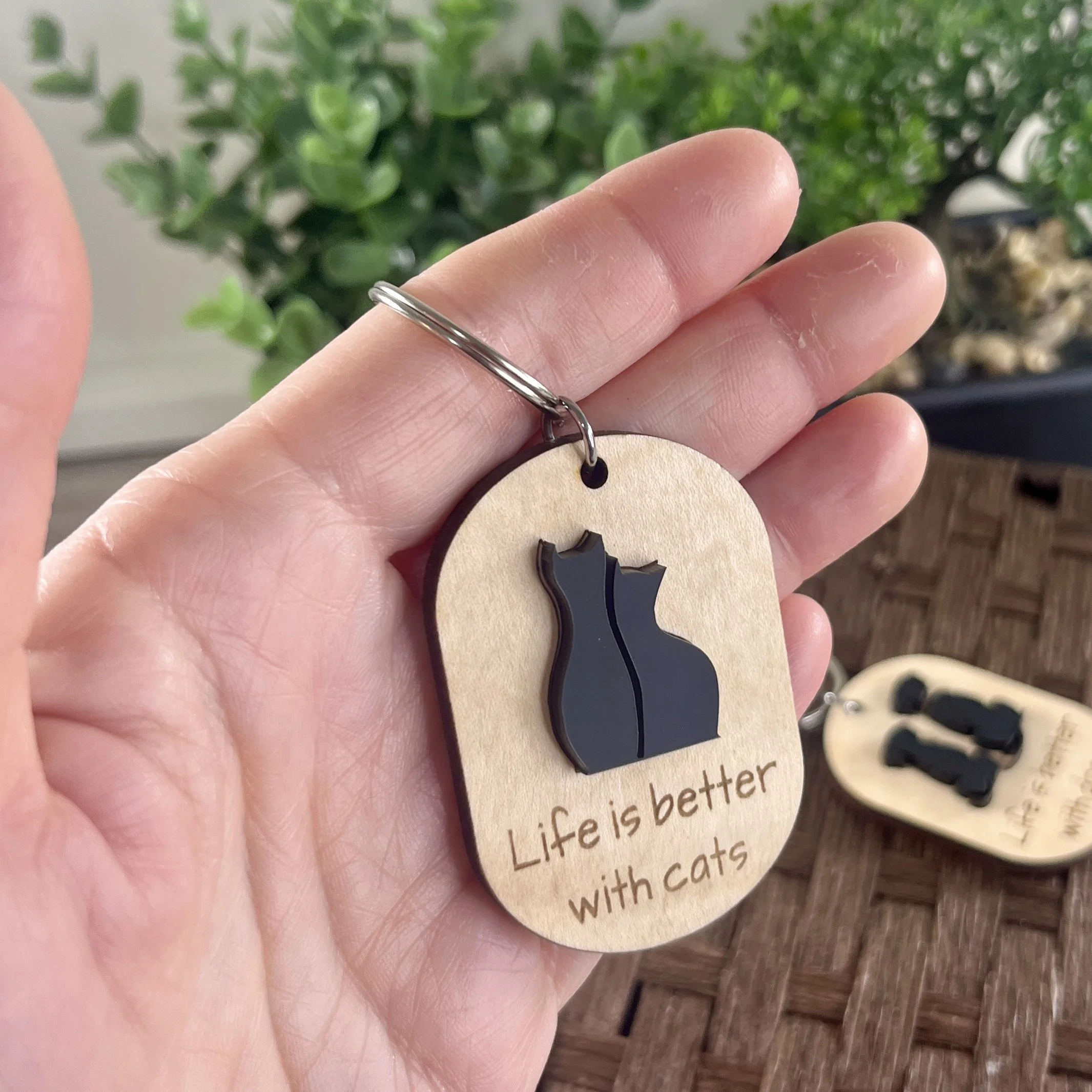 handheld laser cut maple wood keychain with matte black cat silhouette