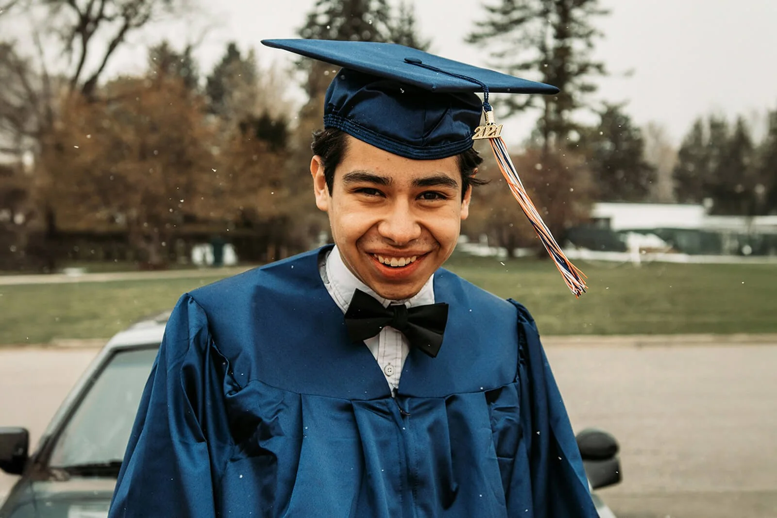 Smiling student in graduation cap and gown walking toward camera, symbolizing life-changing outcomes at Grace Place School. CTA “You can pave the Road to Hope.”