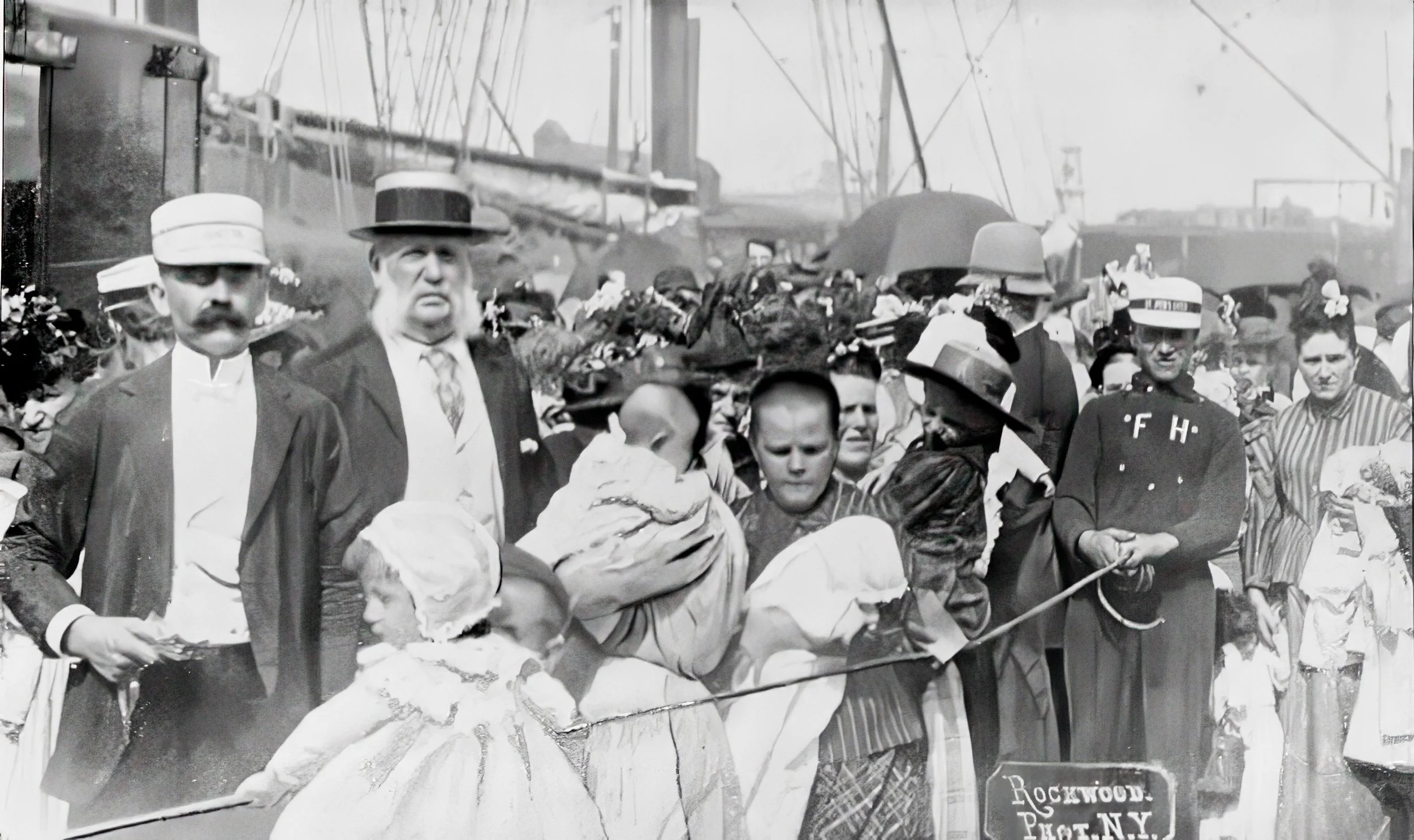 1892 image of the two doctors inspecting the passengers as they board the Floating Hospital.