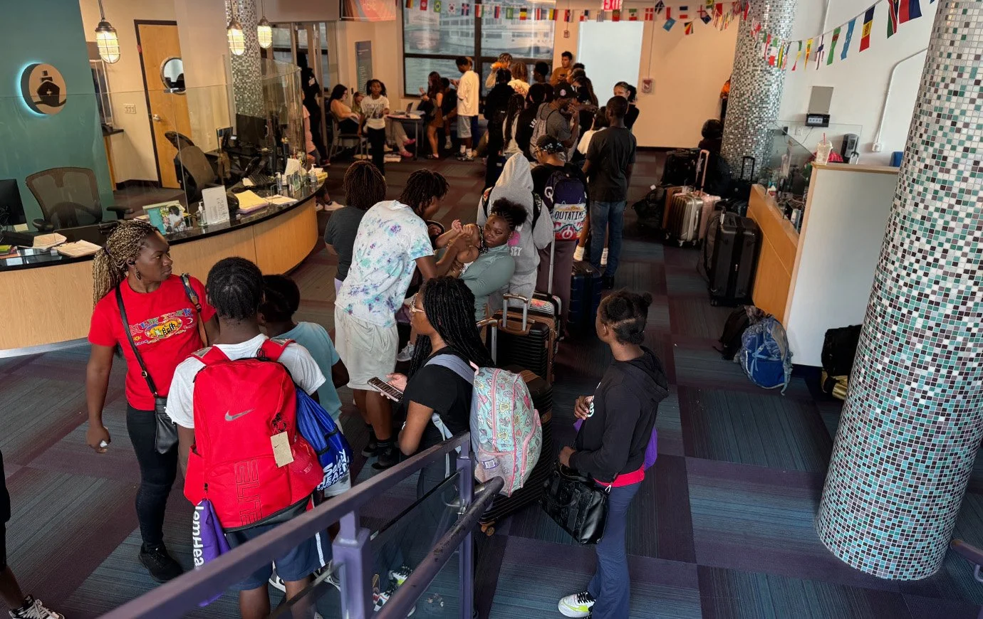 Teens line up to check in and gather their camp supplies.
