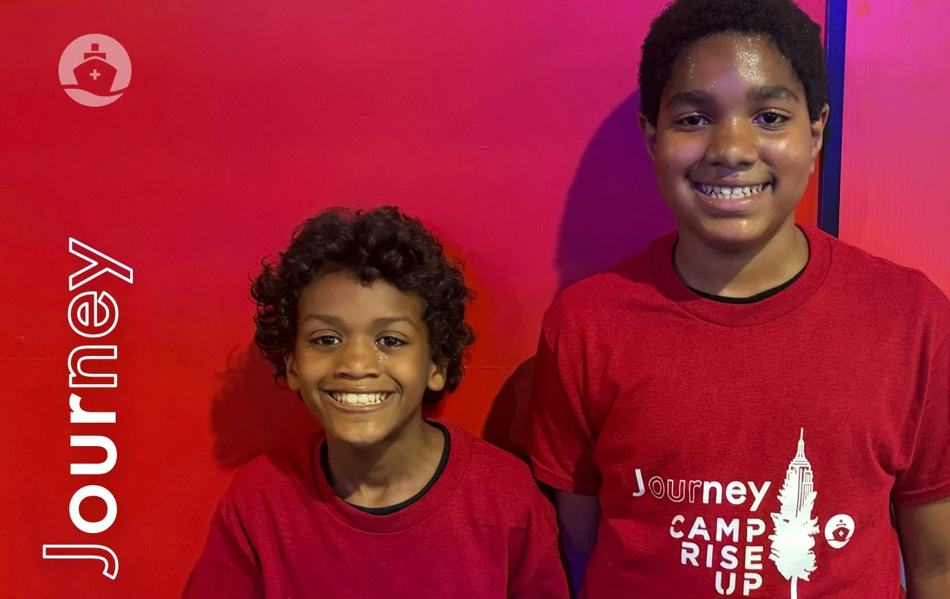Two boys in red t-shits pose at Journey's afternoon activity