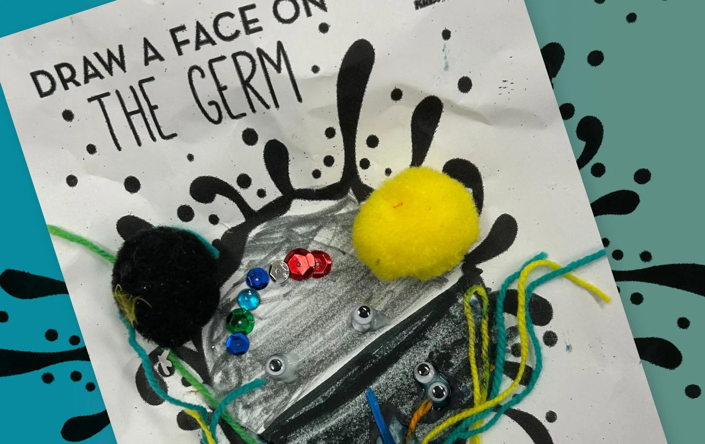 A project sheet from our health education classroom titled "Draw a face on the germ," colored with crayon, colored threads, sequins, a black and yellow pom pom, and not forgetting, some googly eyes. What creativity!