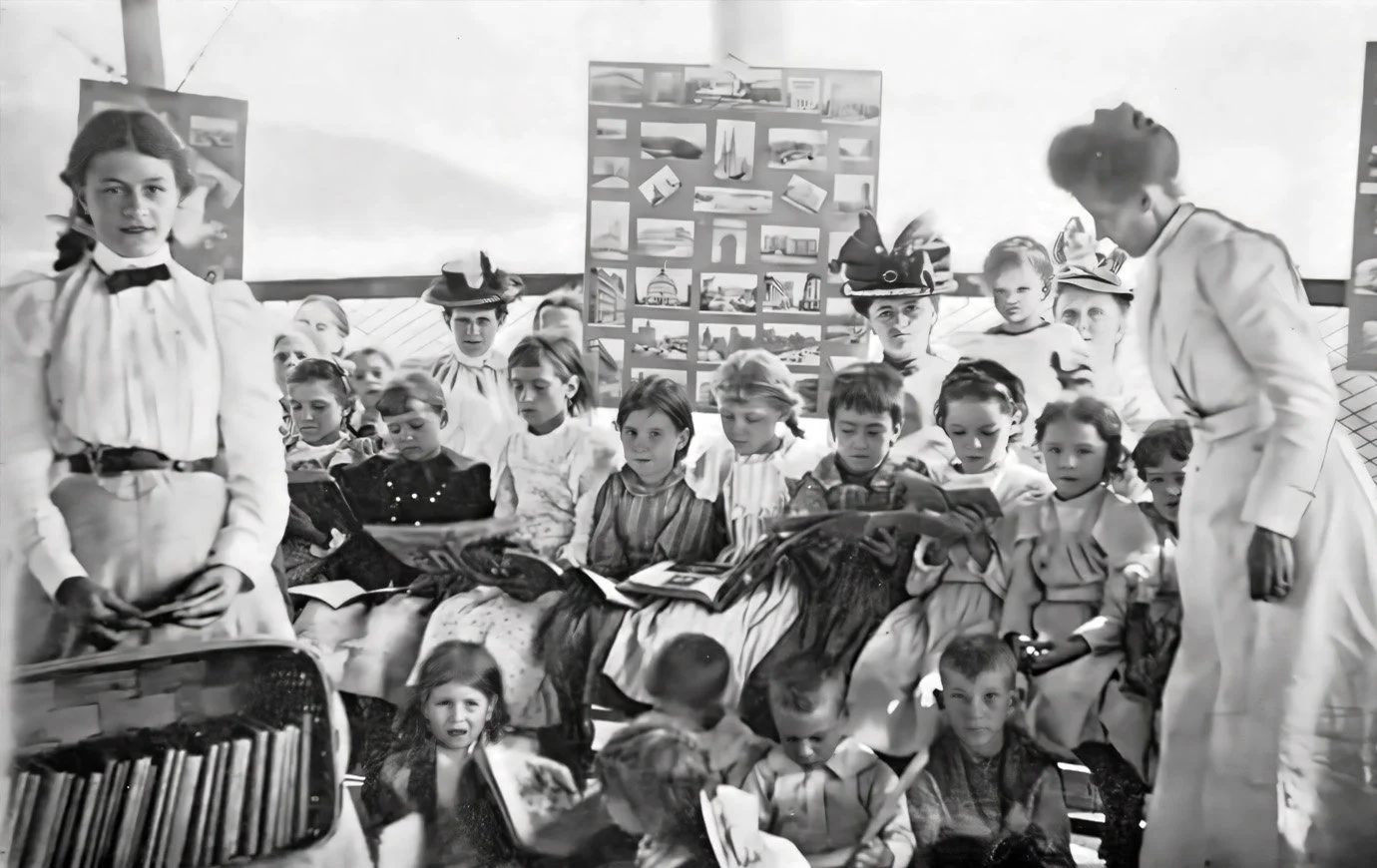 1899 travelling library onboard the Helen C. Juilliard, with Miss Pierson at right.
