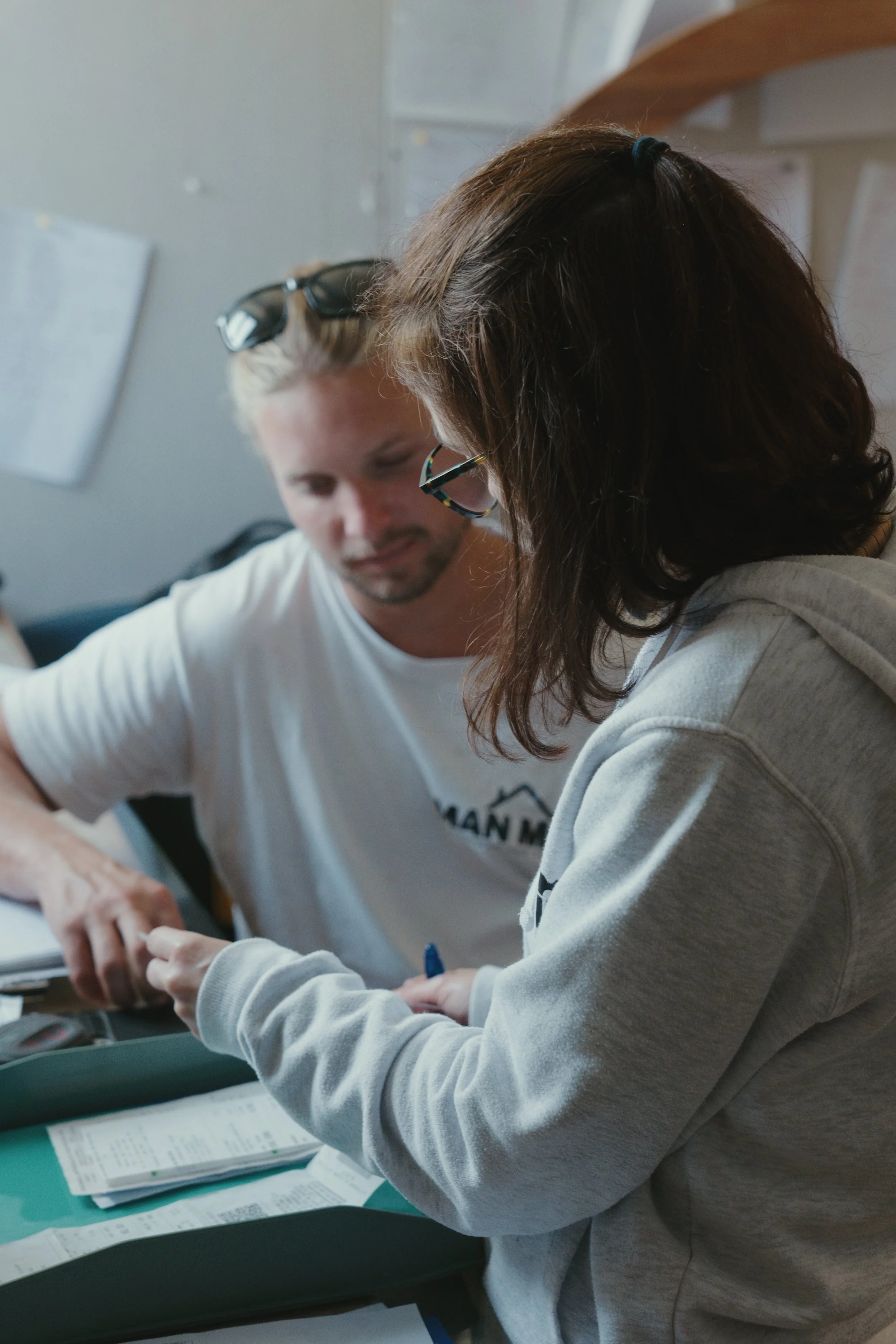 Two people reviewing custom furniture plans at a desk in the ManMade studio.