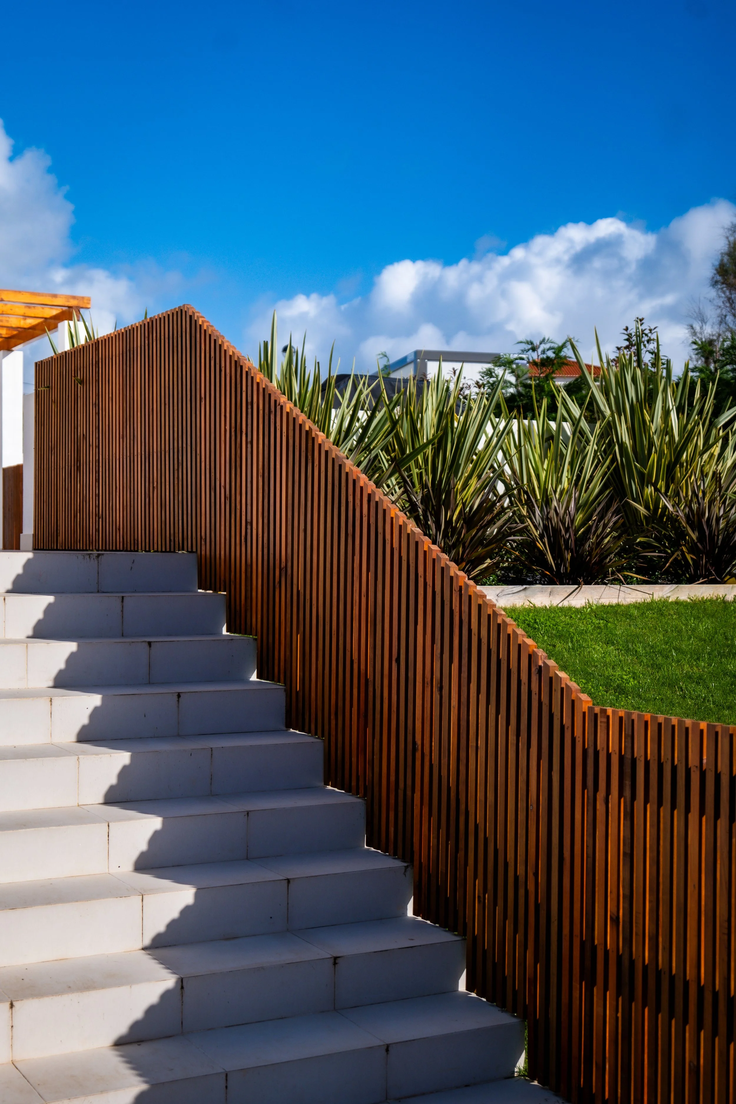 Custom slatted wooden fence in a modern garden