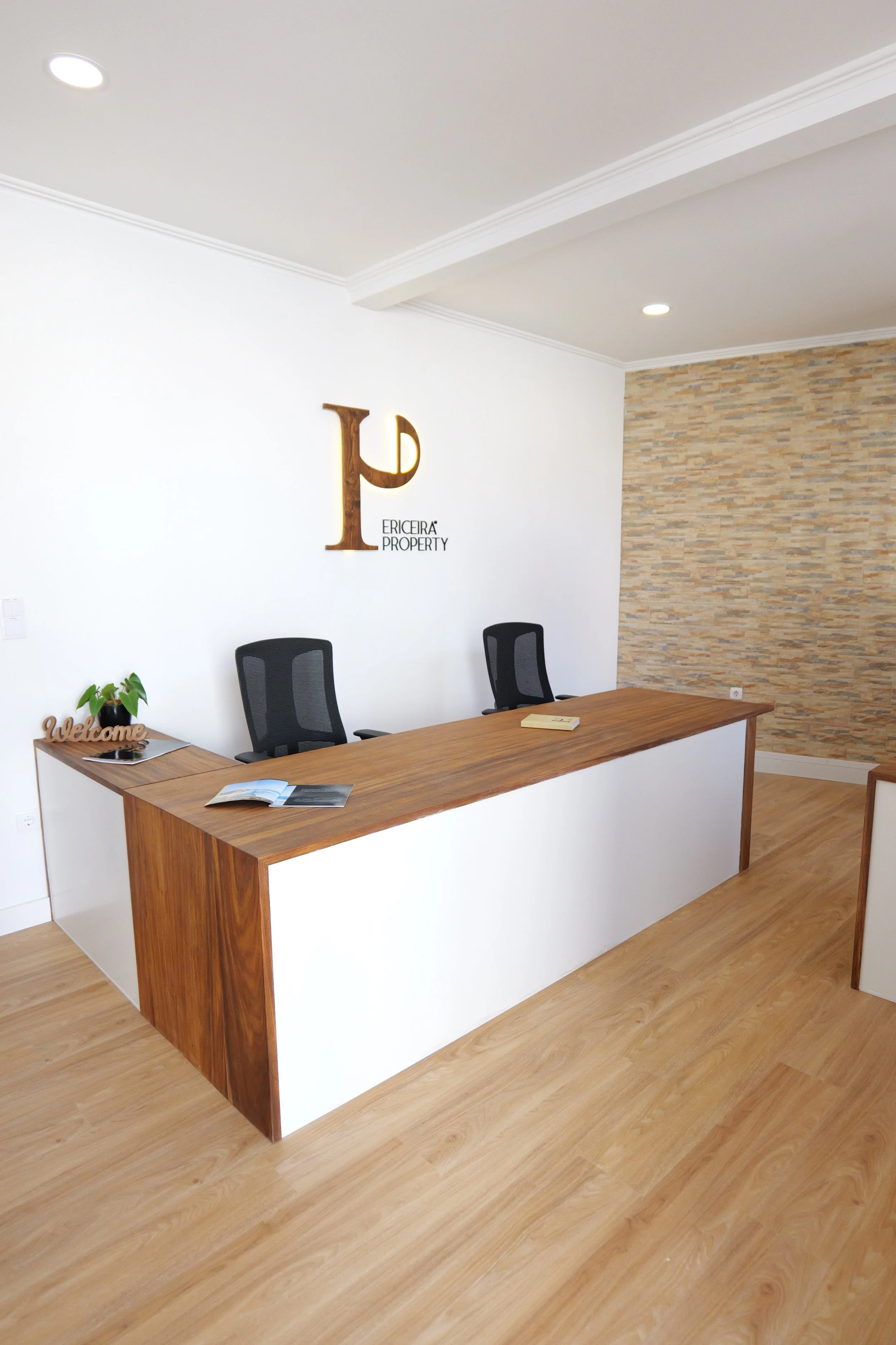 Interior design studio office with Kambala solid-wood desktops and matching wall backing panels.