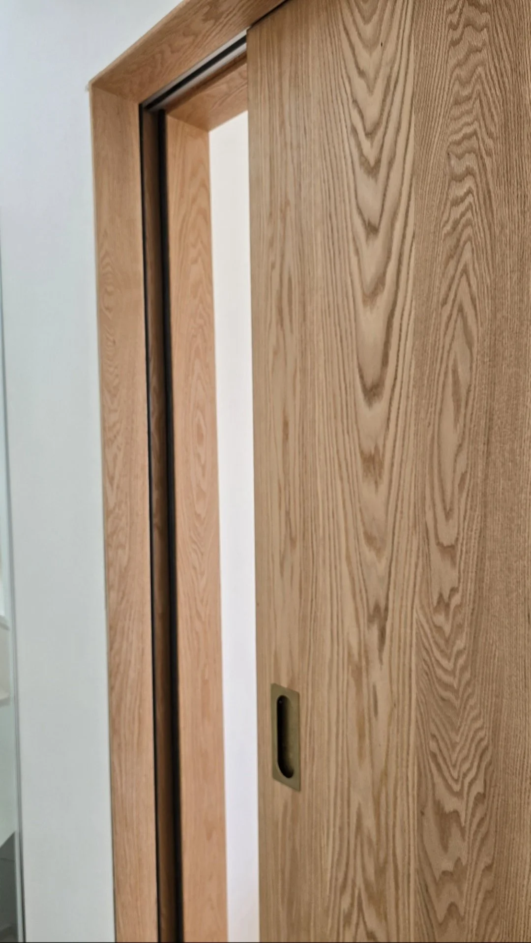 Close-up of natural oak grain and finish on handcrafted solid oak sliding door