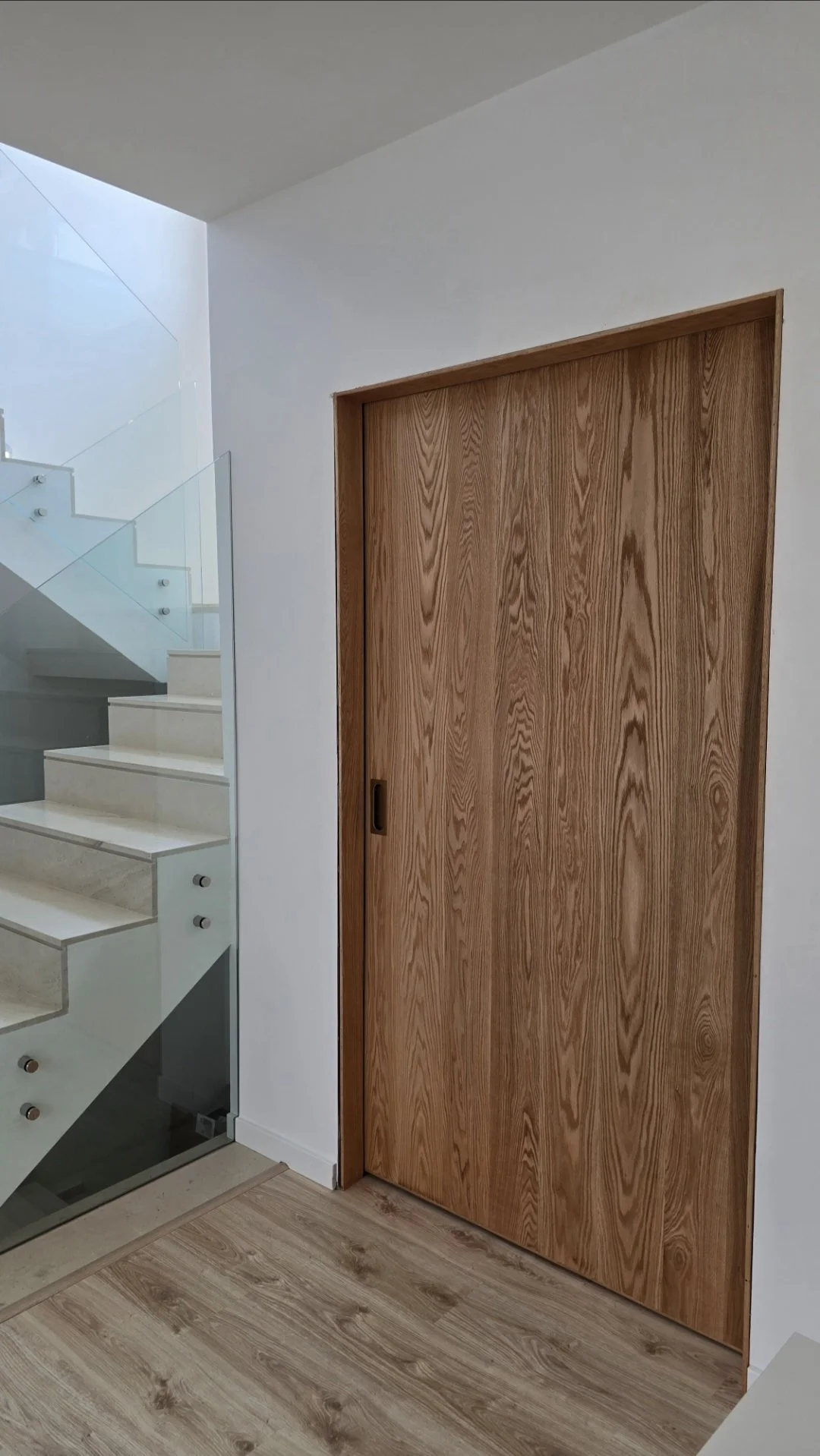 Fully handcrafted solid oak sliding door shown in closed position