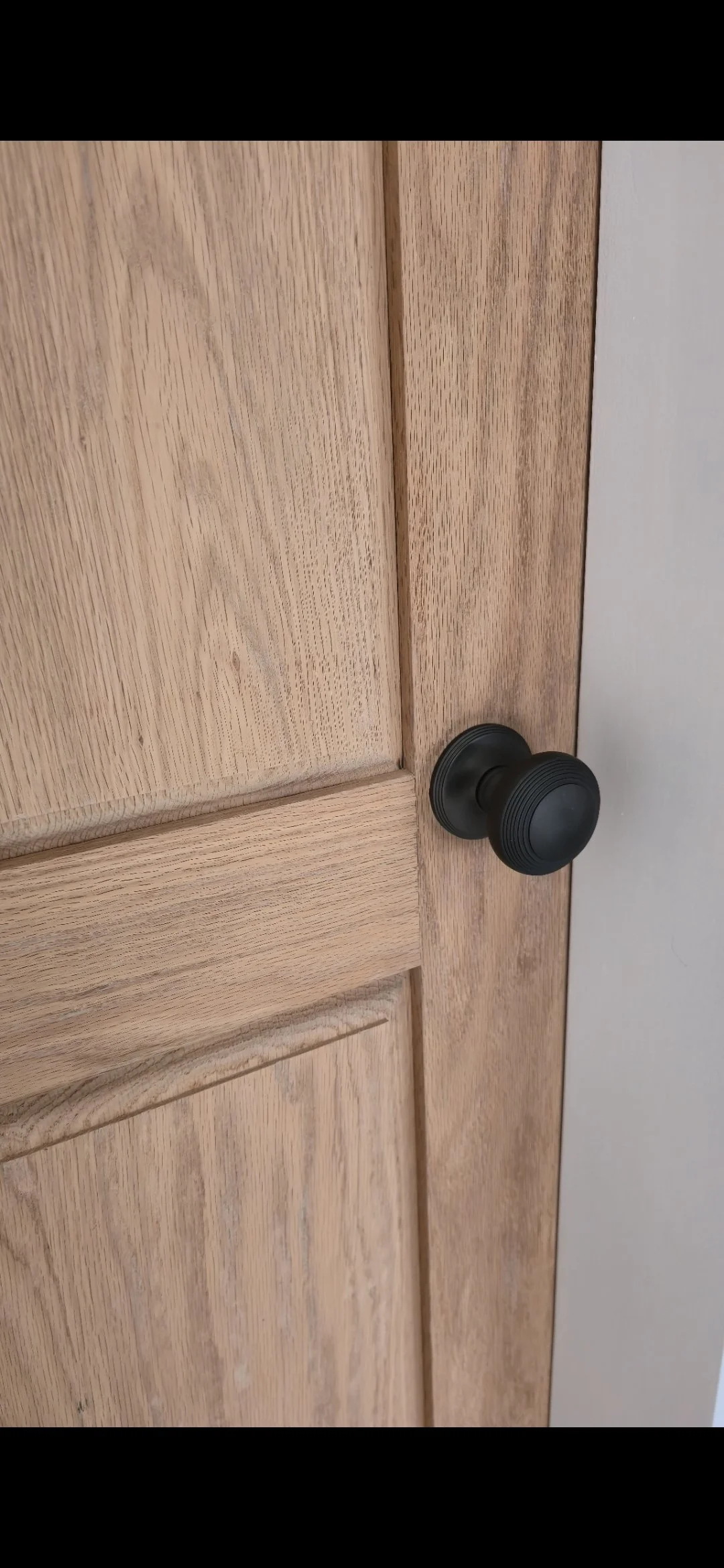 Close-up of bespoke solid oak door with handle detail