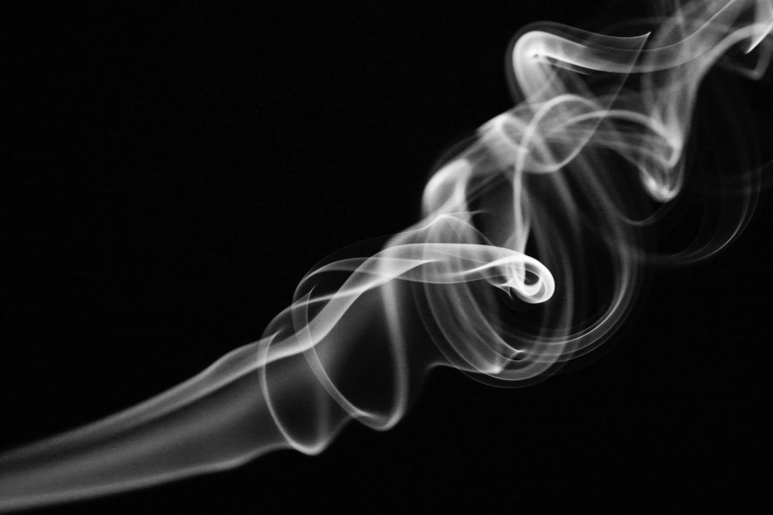 White smoke curling against a black background.