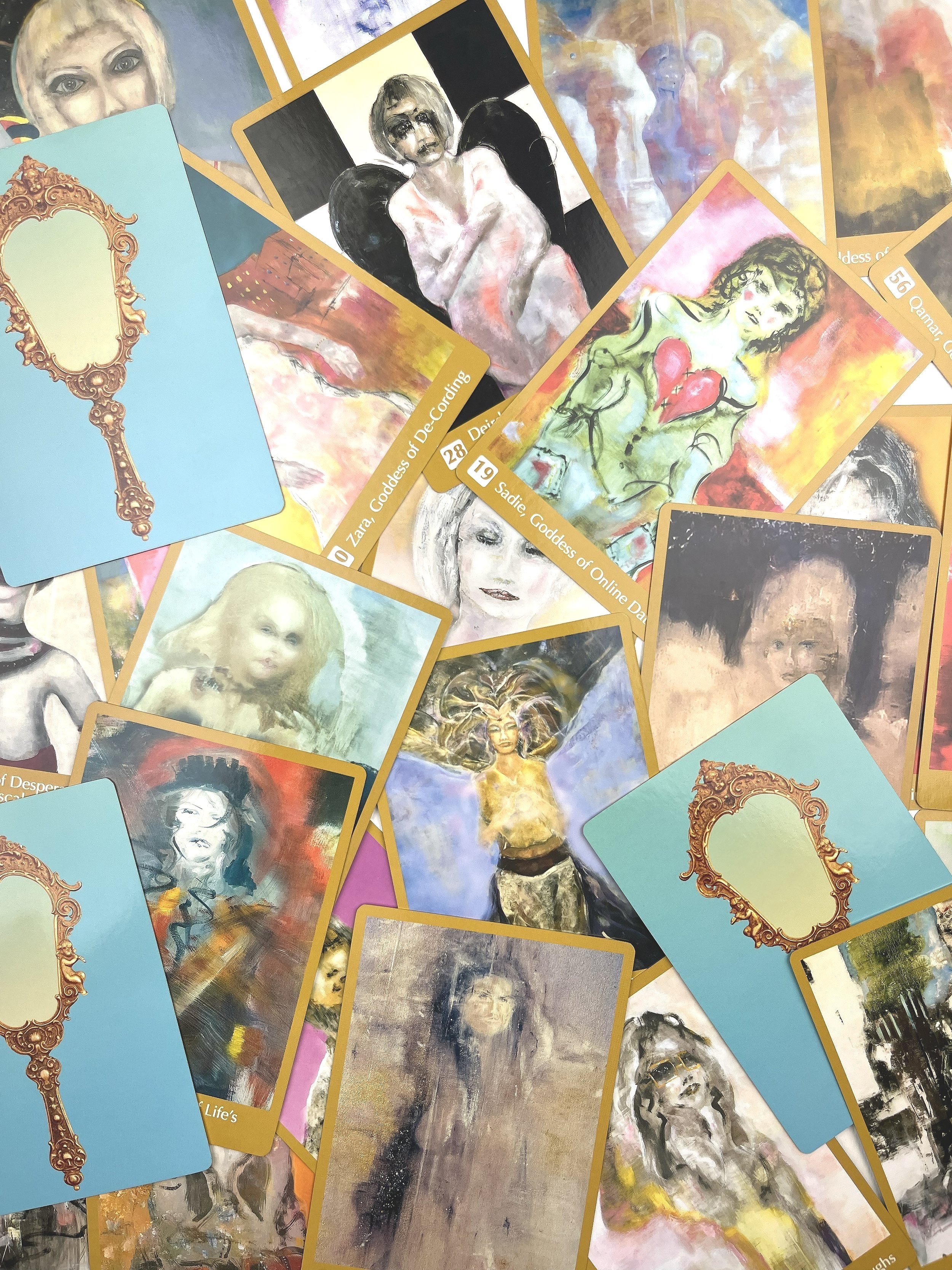 Goddess in Your Mirror Oracle Cards scattered on a table.