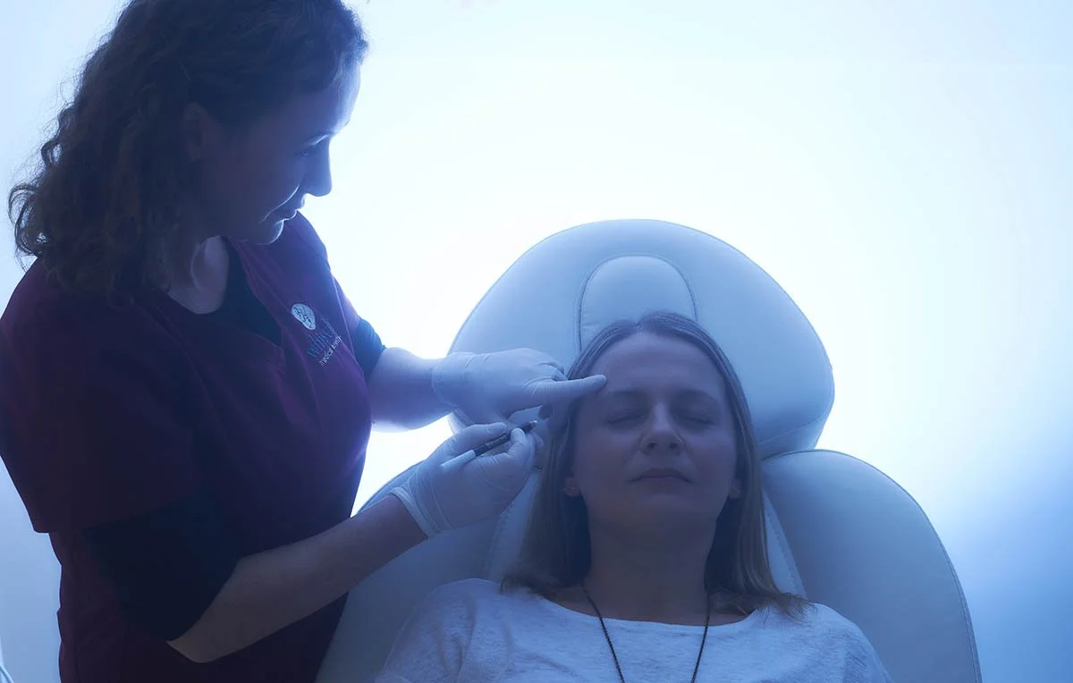 Dr. Kennea is marking up a patient with a trasnparent line pencil to help guide the treatment plan, and allow the patient to understand better the aim of the plan