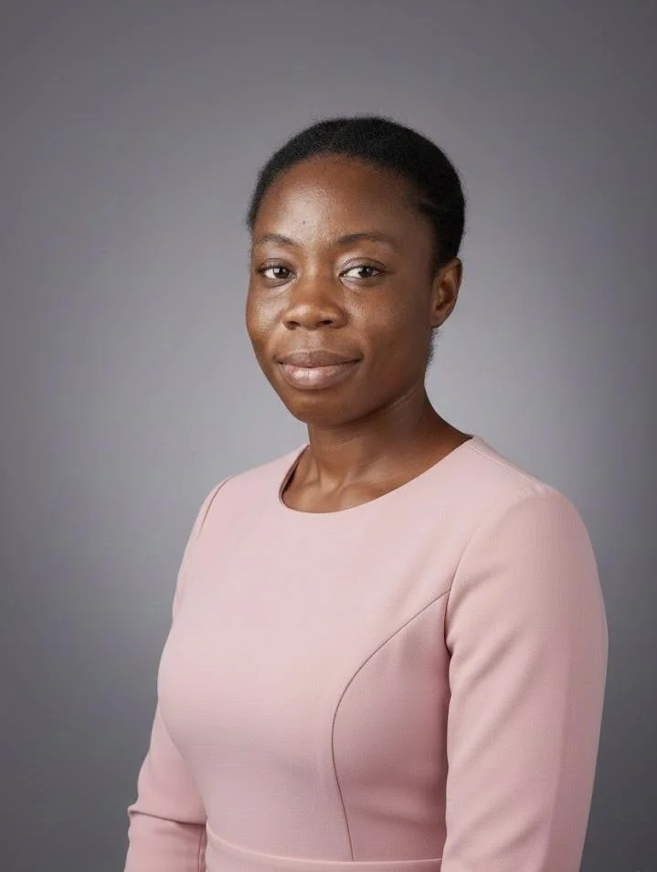 Lady in pink/peach dress, afro hair.