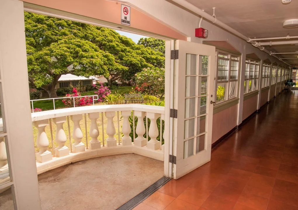 An enclosed veranda overlooks the verdant grounds.