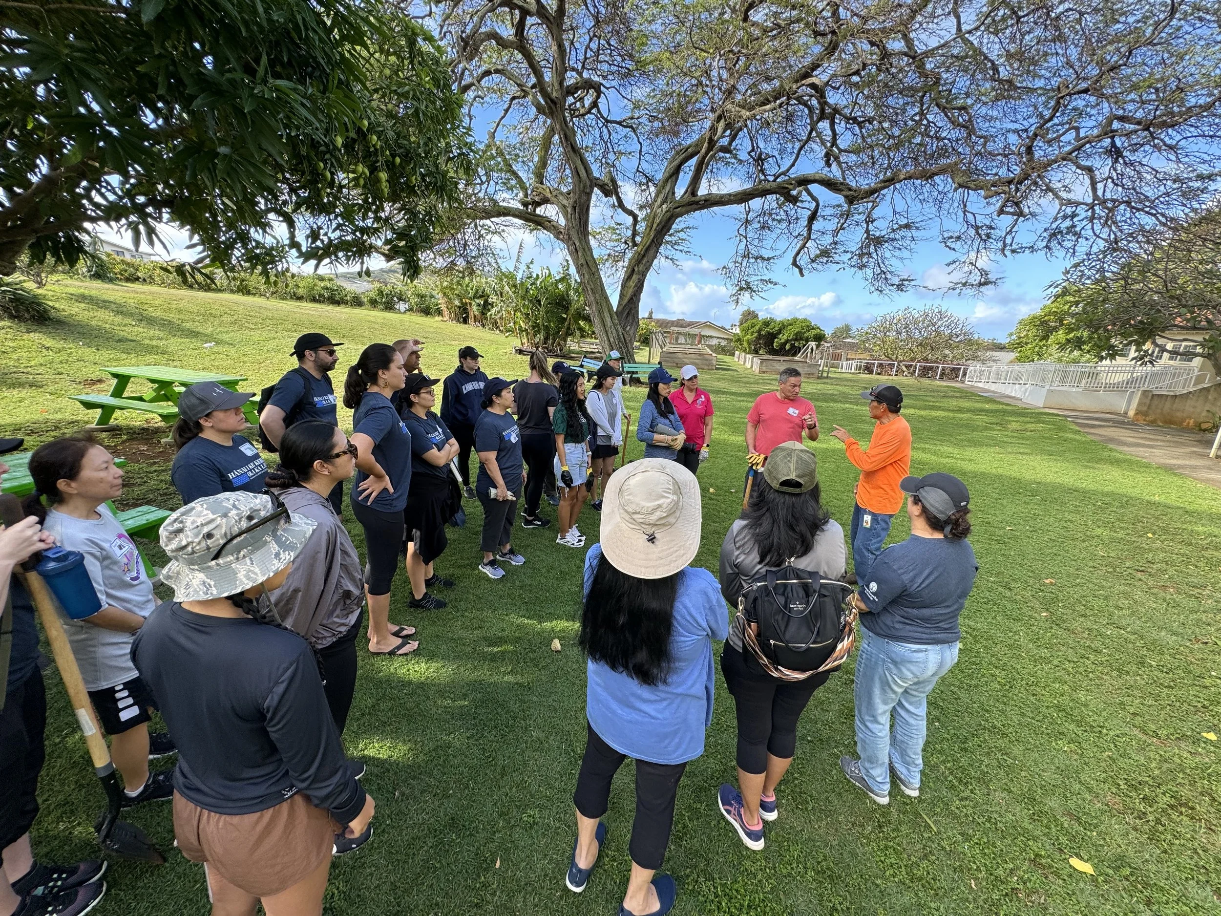 Volunteer event of the King Lunalilo Trust with volunteers listening attentively to a discussion