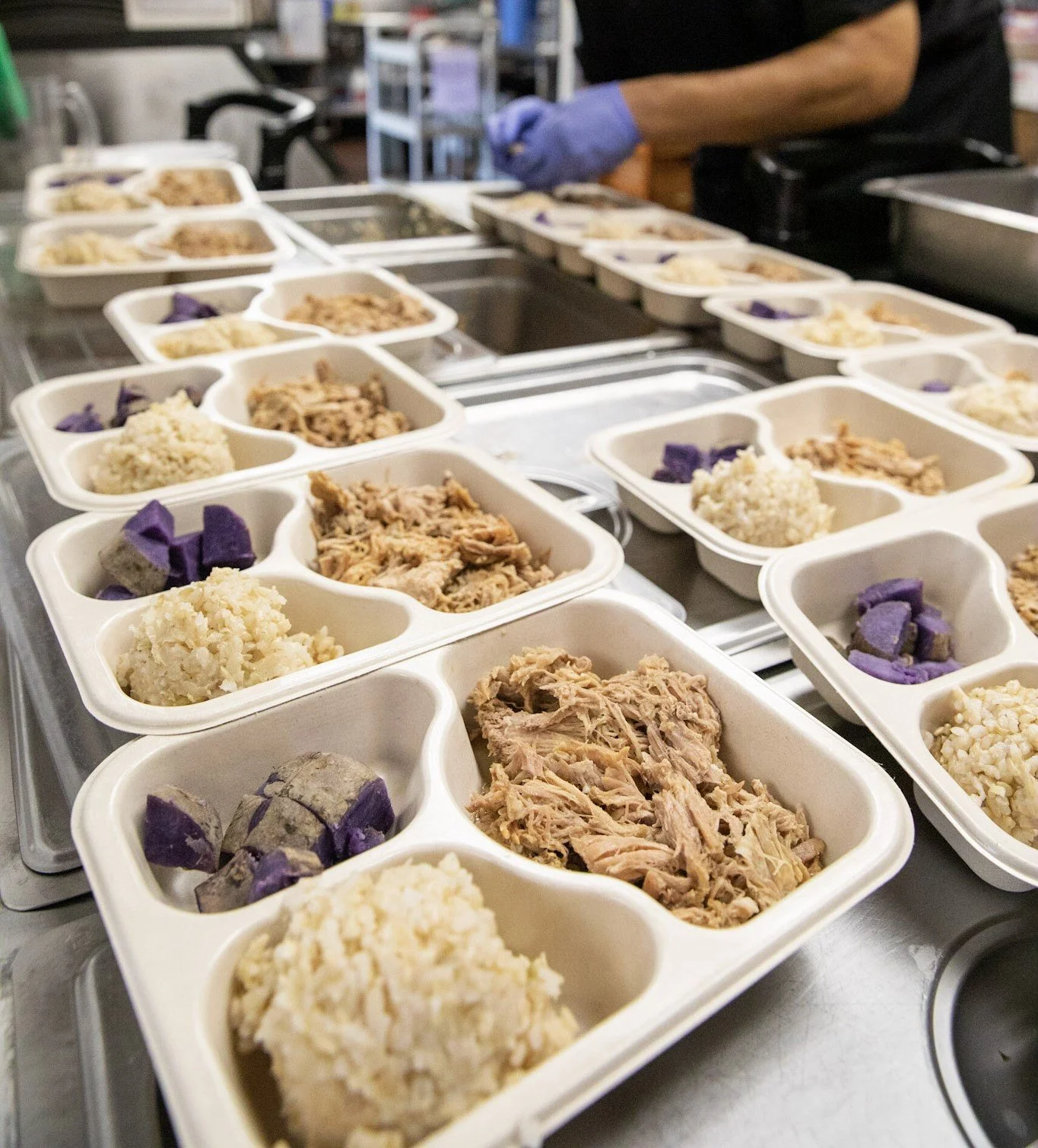 Prepped meals of kulua pork, rice, and purple sweet potatoes for the Meals to Go service