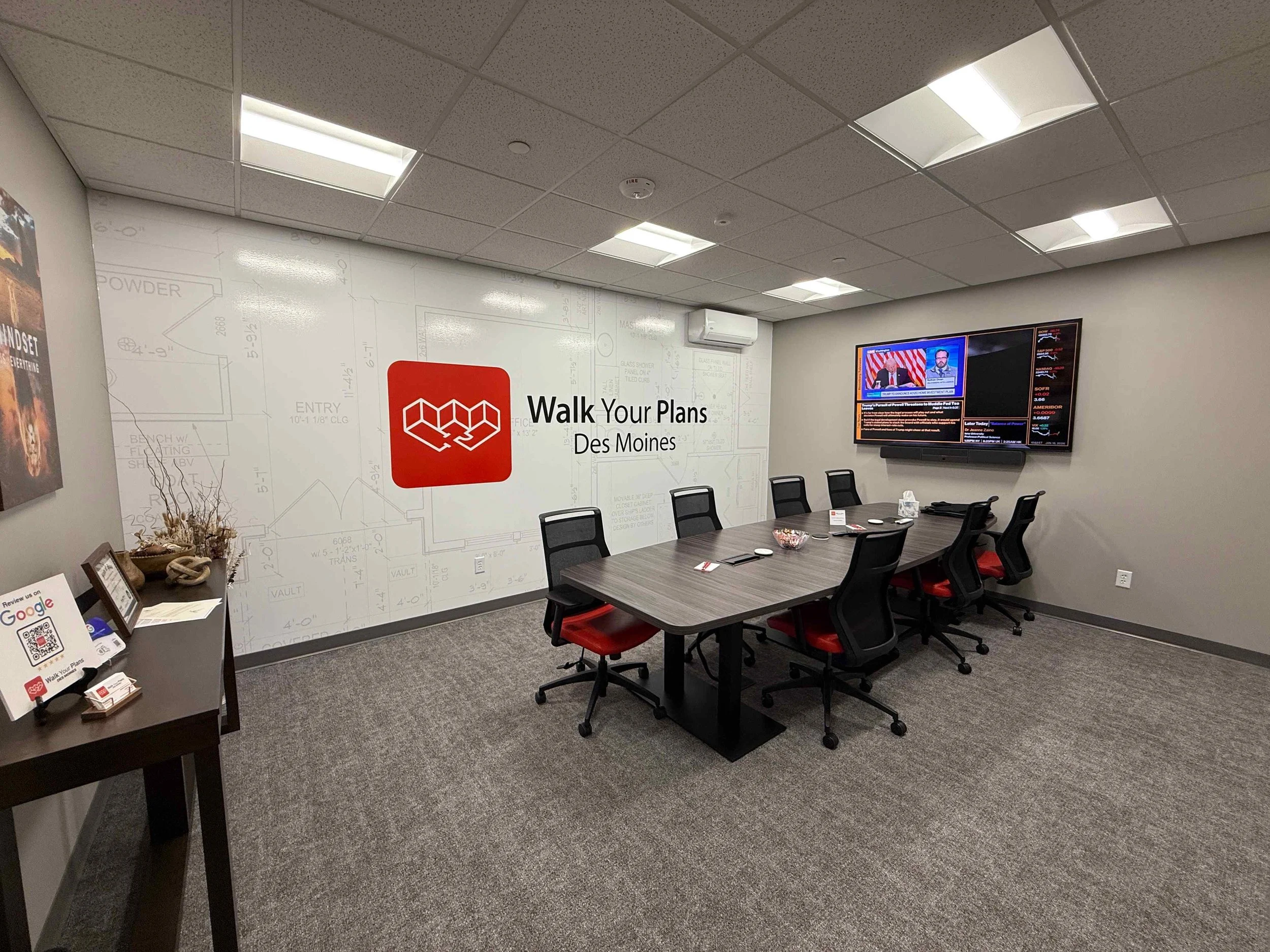 A young man sitting on a beige bench against a plain background, wearing a gray polo shirt and light-colored pants, with a serious expression and shadows cast on the wall.