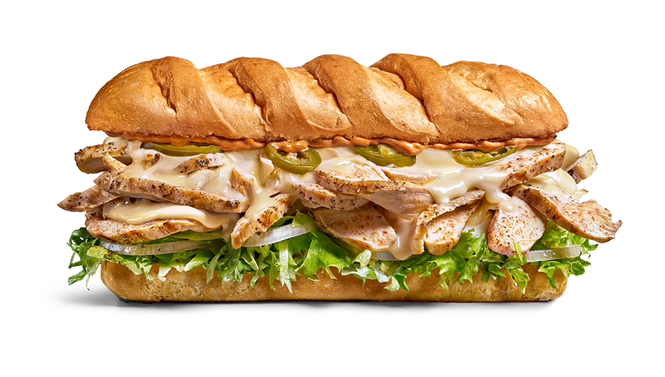 A sub sandwich with grilled chicken, lettuce, pickles, melted cheese, and jalapenos on a toasted hoagie bun.