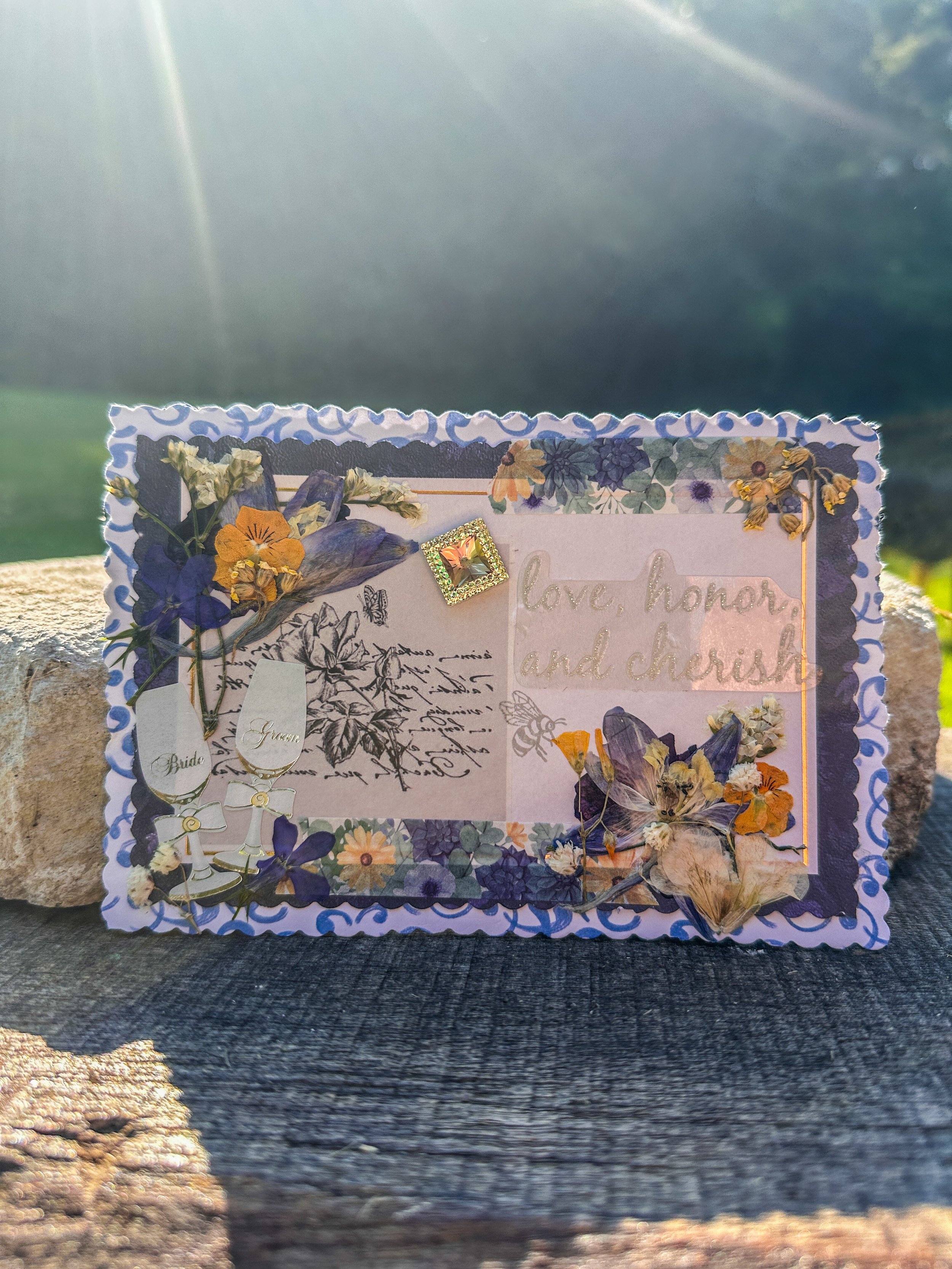 handmade wedding card with pressed flowers and other embellishments