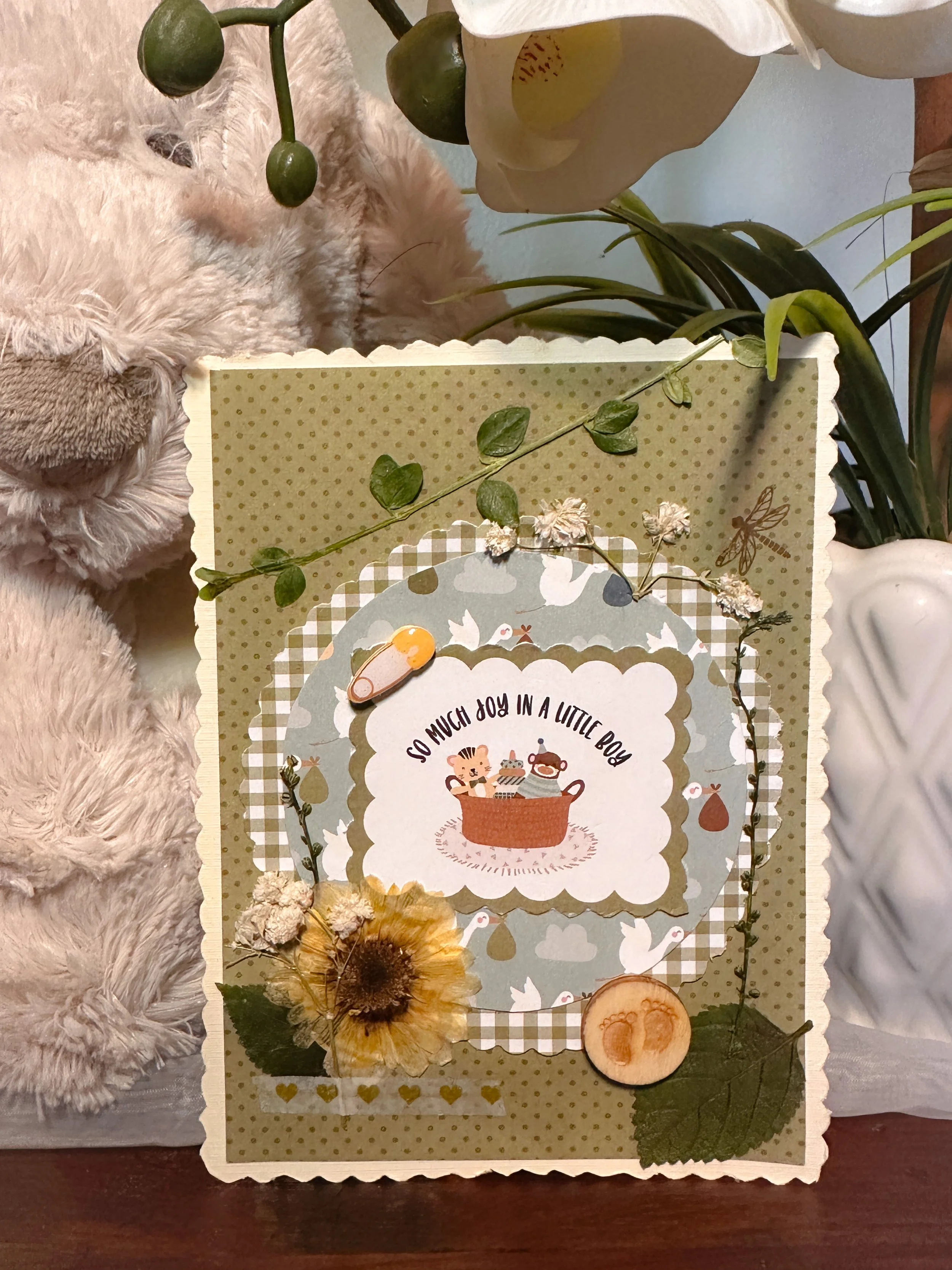 handmade new baby card with pressed flowers and other embellishments