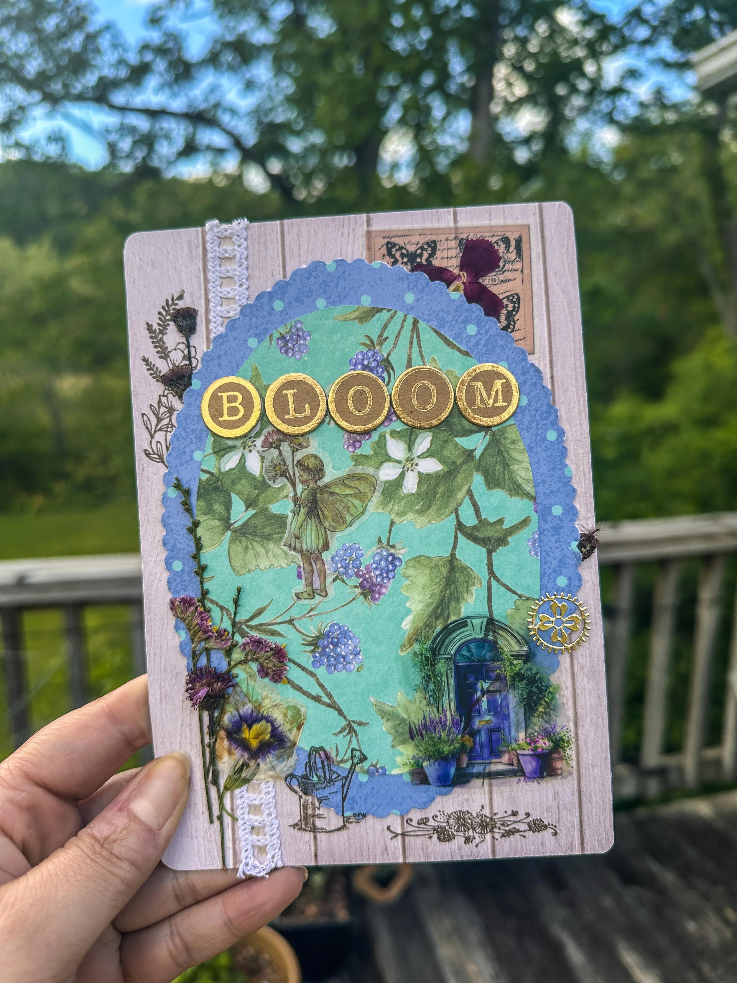 handmade note card with pressed flowers and other embellishments