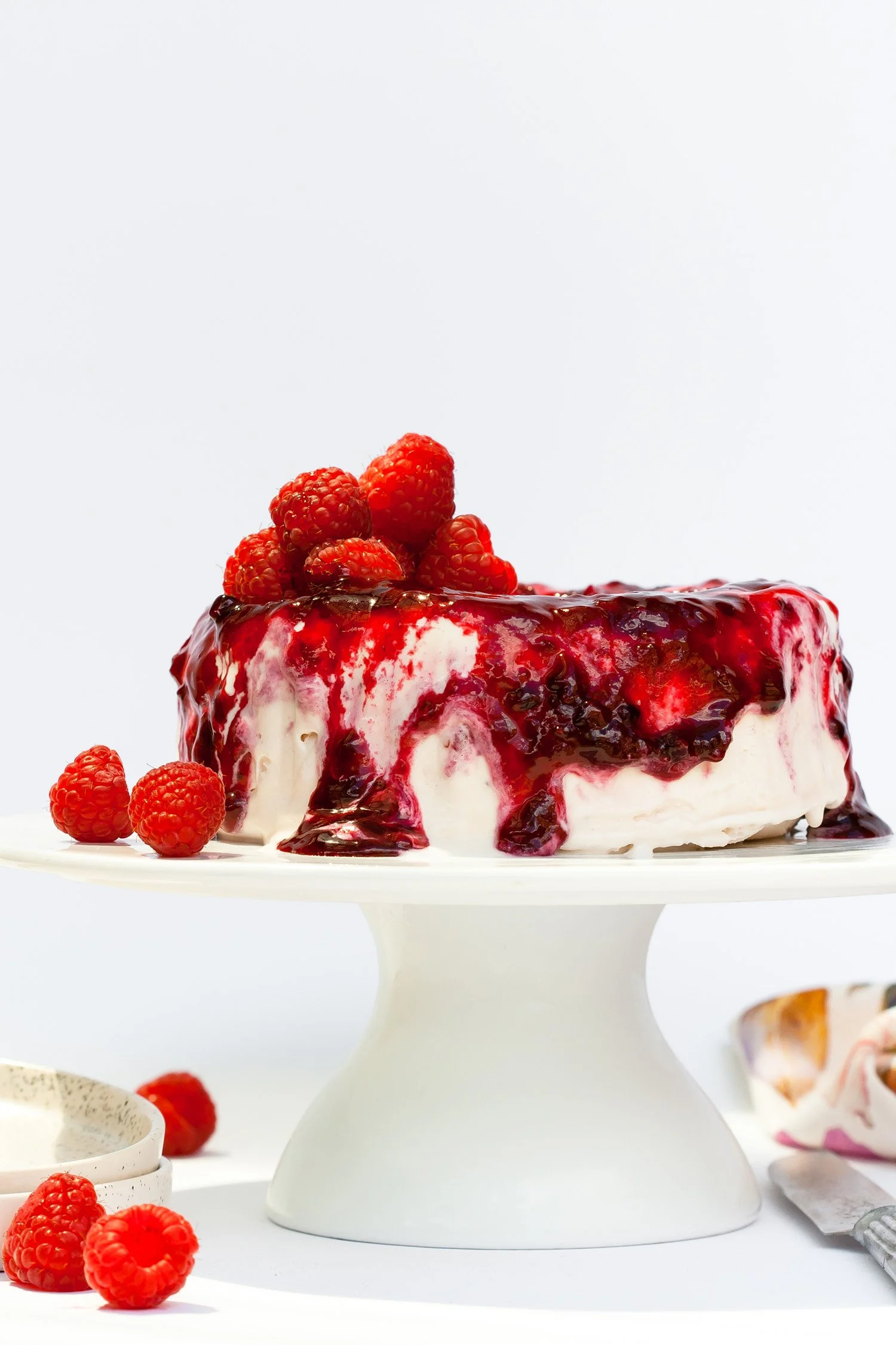 Berry Bomb Ice Cream Cake on Stand with additional garnish