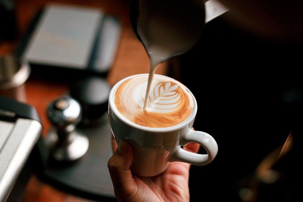 Barista making latte art in Dallas