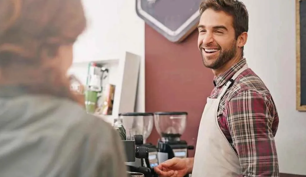 Barista serving latte at a Texas event