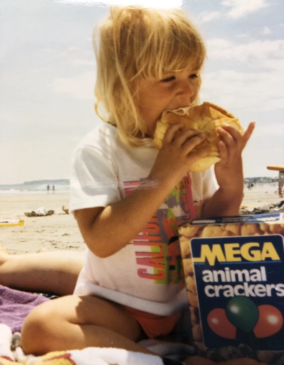 Kid eating a sandwich on the beach