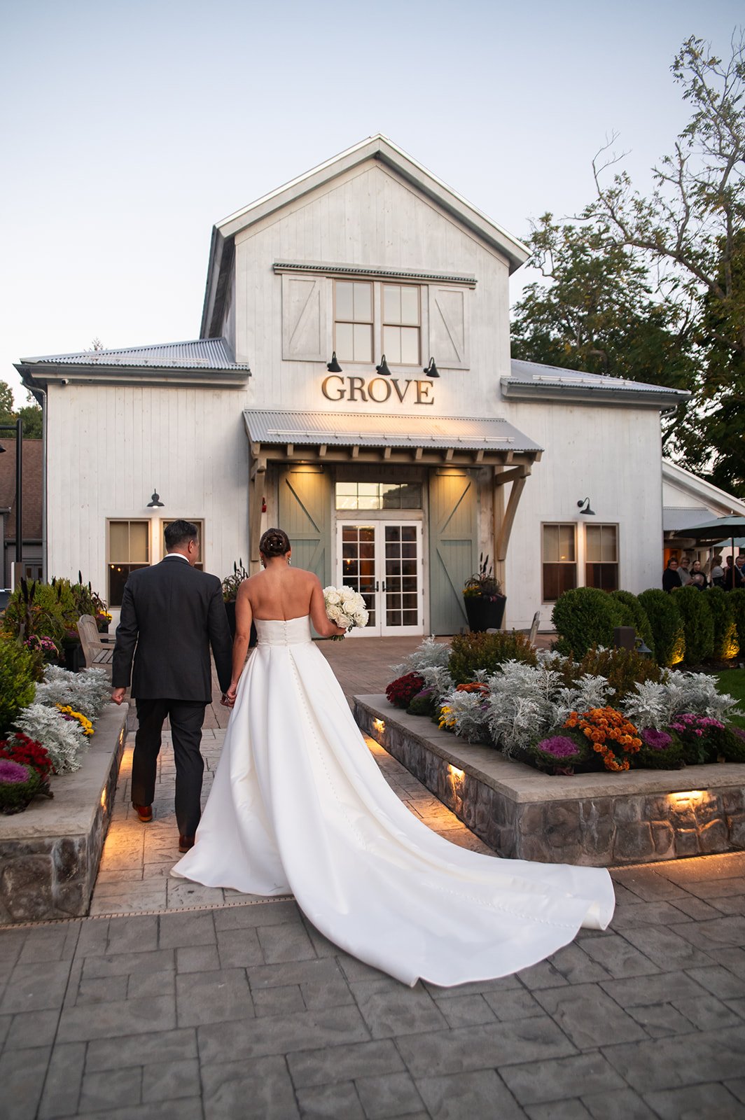 bride and groom walking towards reception area at Grove at Briar Barn Inn