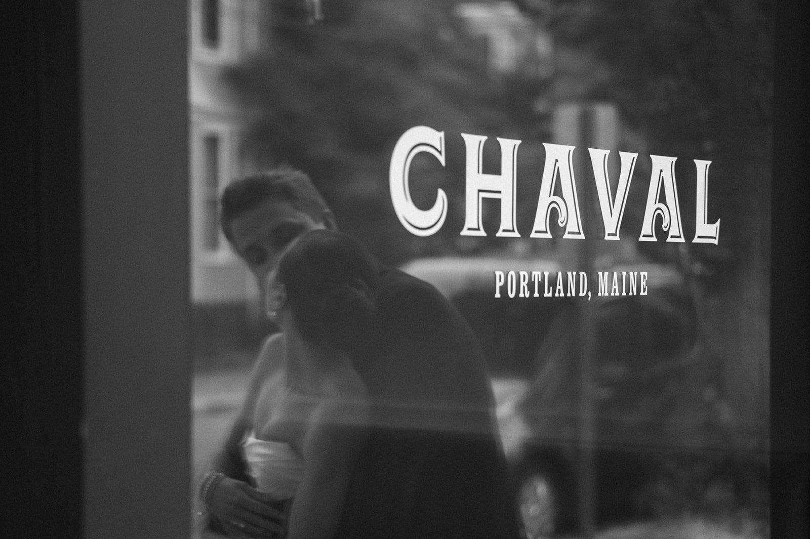bride and groom dancing in reflection of maine restaurant window