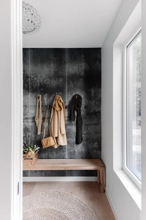 A house's mudroom, styled with Scandi-inspired minimalist decor, covered by Hygge Design's full interior design service.