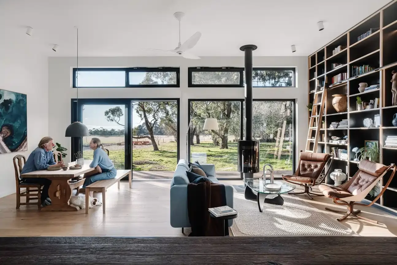 A light-filled open concept home combining the living area and dining, styled in minimalist Scandi-inspired decor directed by Hygge Design during interior design initial consultation.
