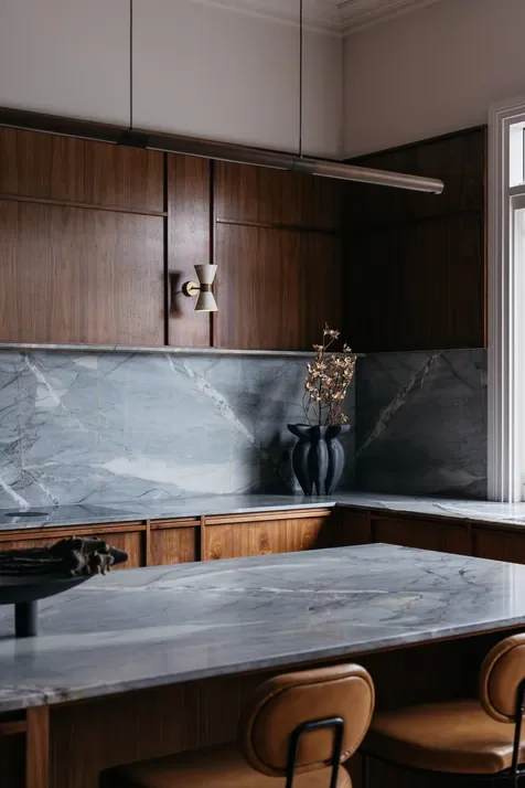 A minimalist kitchen area featuring grey marble countertops, designed by Hygge Design, interior stylists in Beaumaris, Melbourne