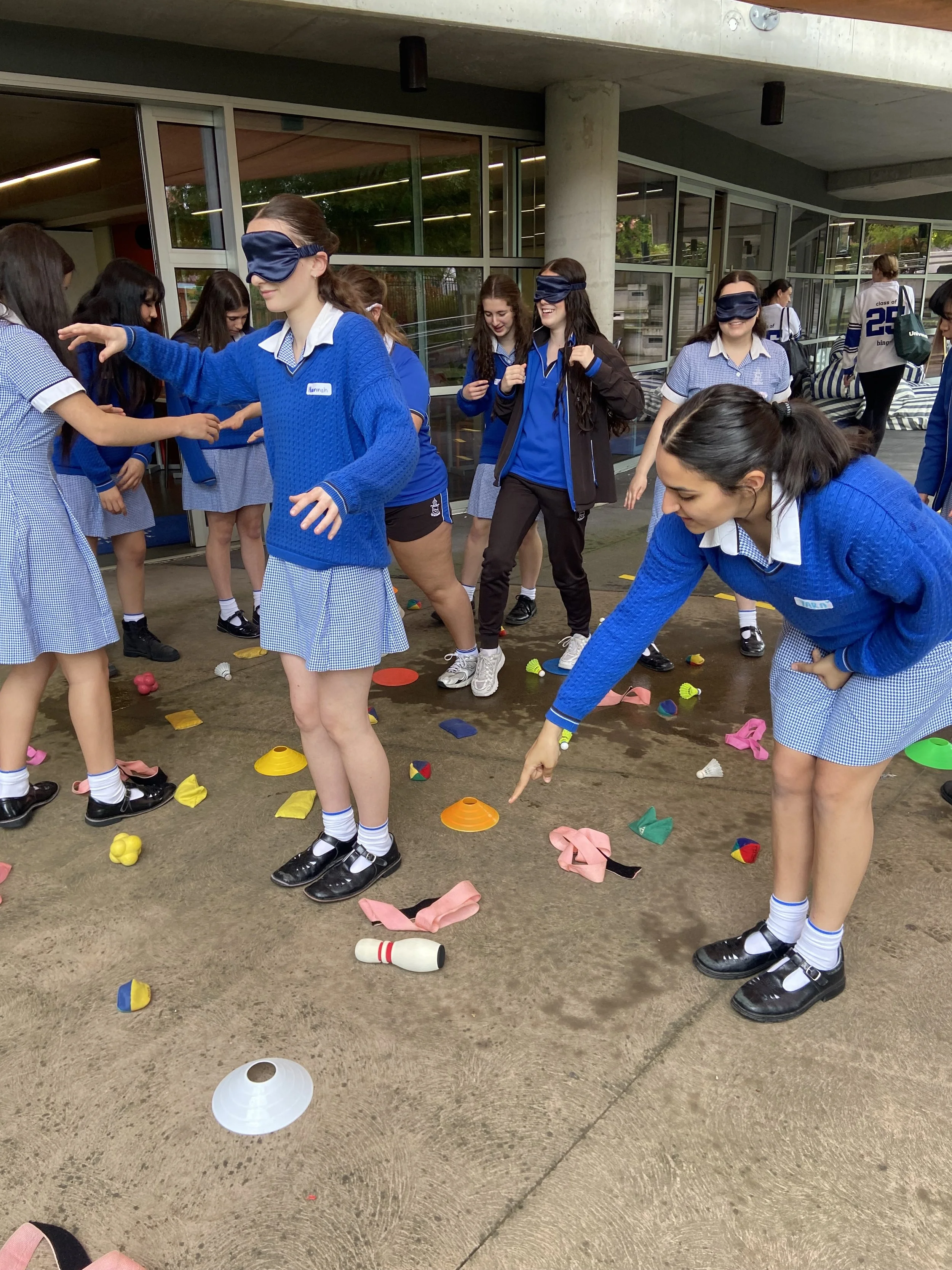 Students playing a game outdoors during workshop to practice problem solving and communication.