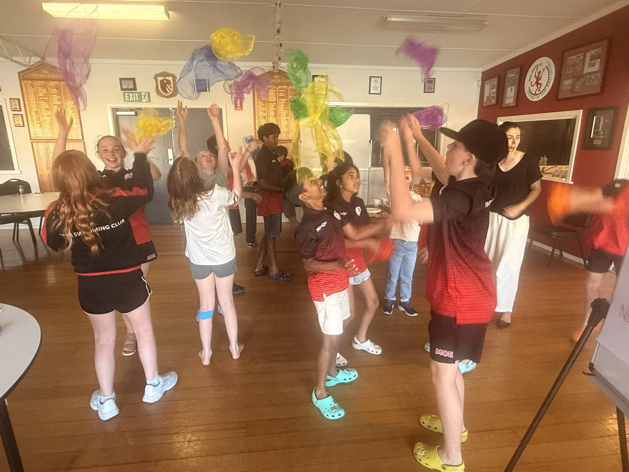 Junior athletes at swim organisation participating in fun, interactive activities for understanding of emotional regulation and emotional literacy.