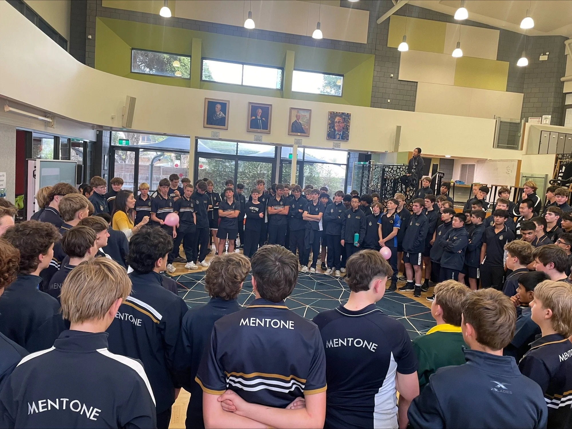 Middle school boys participating in an interactive wellbeing activity during a Being Human Co workshop.
