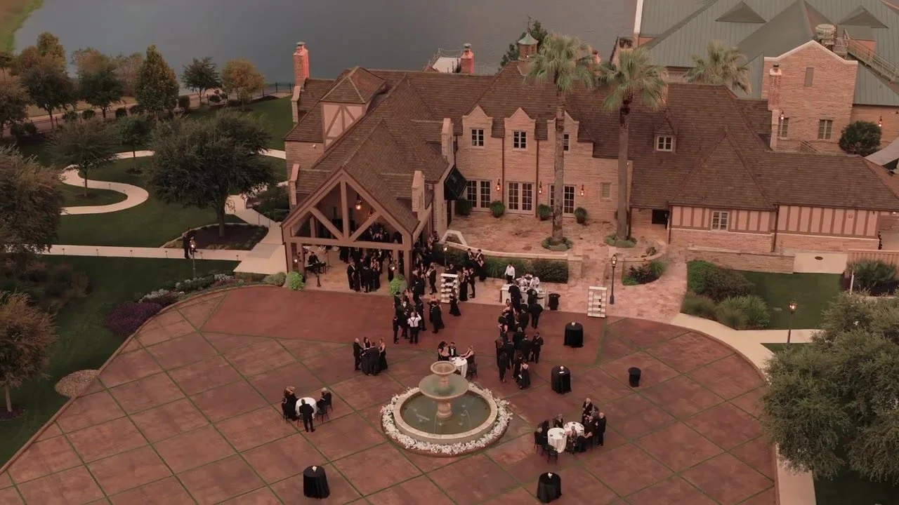 Aerial view of guests gathering in the mansion courtyard by the fountain at Red Berry Estate