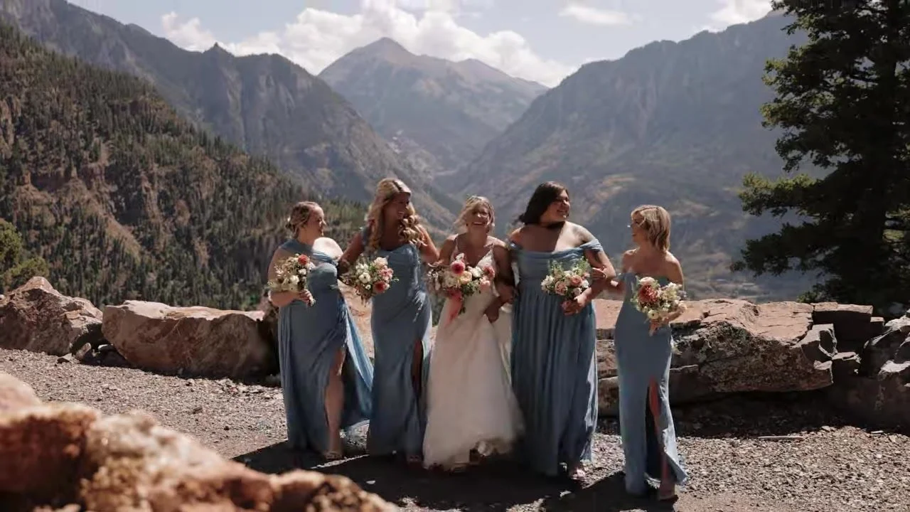 Madeline and four bridesmaids in dusty blue on a mountain path at Gold Mountain