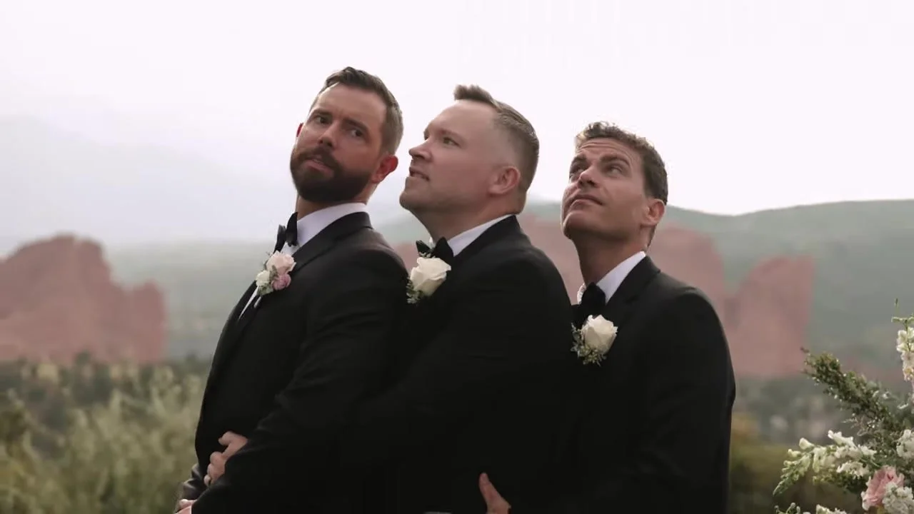 Groomsmen in black tuxedos with Garden of the Gods behind them